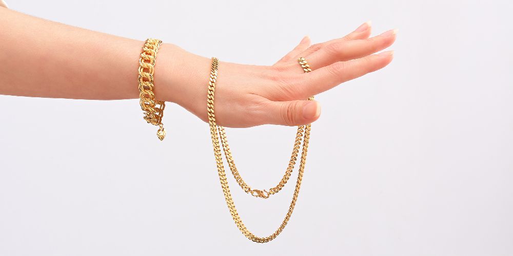 Hand wearing layered jewellery